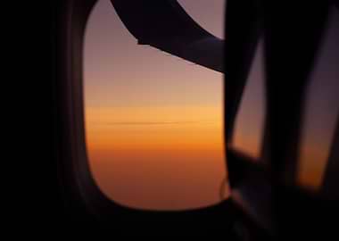 Airplane window view at sunset