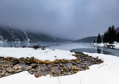 Winter landscape with a stream and a lake