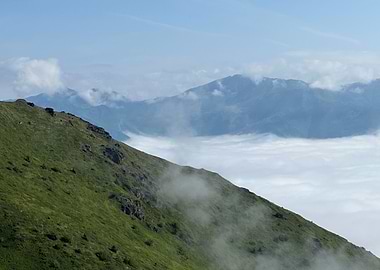 Green Mountain Above Clouds in Alaska