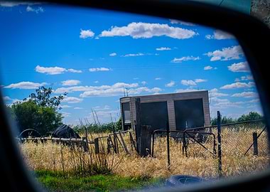 Rural Landscape Reflected in Car Mirror