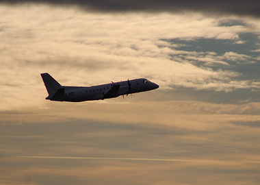 Airplane in Flight Against Cloudy Sky