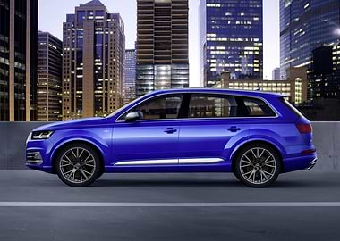 Blue Audi Q7 in Cityscape