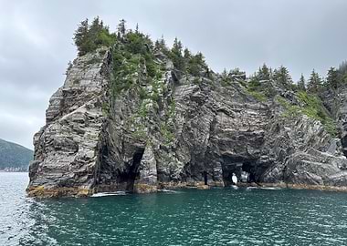 Alaskan Rocky Island with Arches in Ocean
