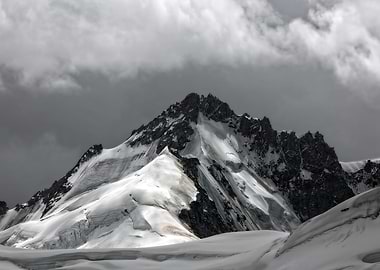 Snowy Mountain Peak Under Cloudy Sky