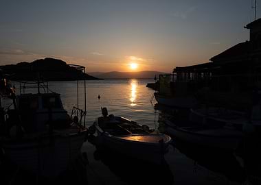Sunset over boats in harbor