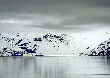 Snowy Mountains Reflecting in Water