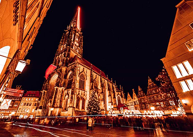 Illuminated Church at Night in Münster with Christmas Market