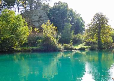Photography of Turquoise River Landscape with Rock Formation