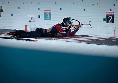 Biathlon Athlete Aiming Rifle in Snow