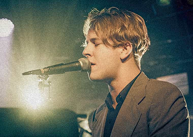 Singer performing on stage with microphone