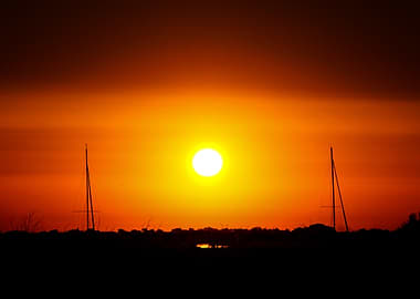 Sunset Between Sailboats Silhouette