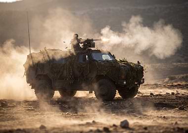 Military Vehicle Firing Weapon in Desert