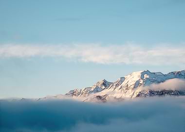 Snowy Mountains Above the Clouds