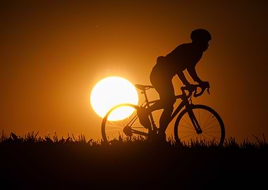 Silhouette of cyclist against setting sun