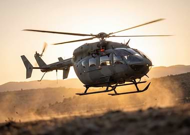 Military Helicopter in Flight at Sunset