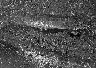 Monochrome Water Flowing Over Rocks