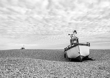 Black and White Boat on Pebble Beach