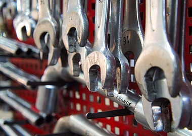 Hanging Wrenches on Red Perforated Panel