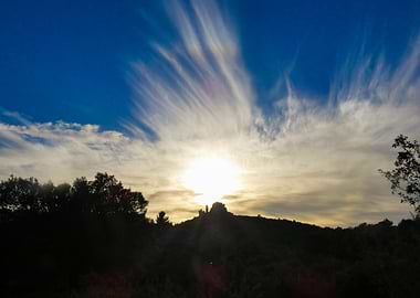 Photography of Sunset over a Castle on a Hill with Clouds in the Alpilles in Provence in France