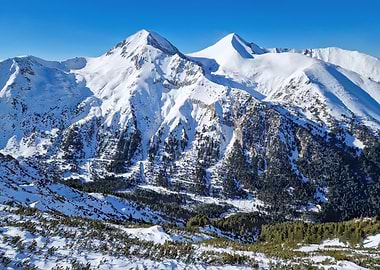Snowy Mountain Peaks Under Blue Sky