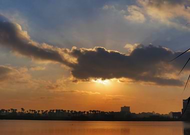 Sunset over water with city skyline
