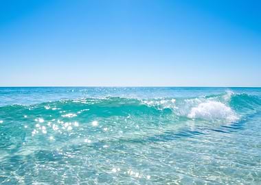 Turquoise Wave Under a Clear Blue Sky