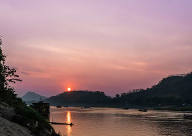 Sunset over river with boats