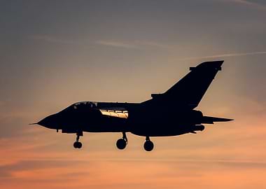Silhouette of a Fighter Jet at Sunset
