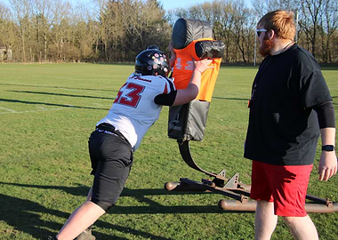 Football Player Training with Coach