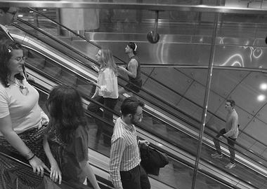 People on Escalator in Black and White