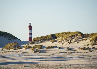 Amrum Lighthouse behind the dunes of the beach