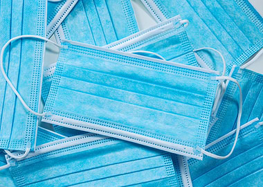 Pile of Blue Surgical Face Masks