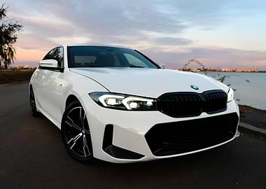 White BMW on Road at Sunset