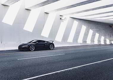 Black Audi R8 under concrete structure
