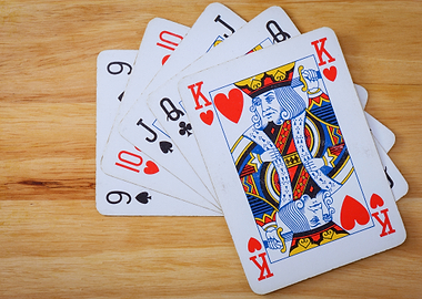 Playing Cards on Wooden Surface