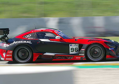Red and Black Racing Car in Motion