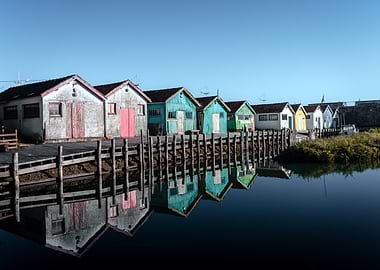 Colorful Boathouses Reflected in Water