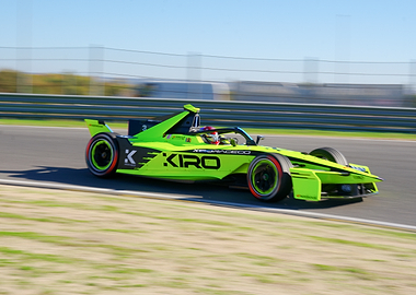 Green Formula E Race Car on Track