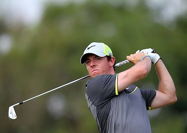 Golfer Rory McIlroy swings his club