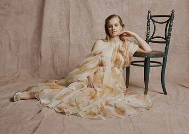 angourie rice in floral dress by chair