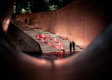 Illuminated Staircase with Red Sculptures at DDP