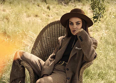 mila kunis in a brown suit and hat