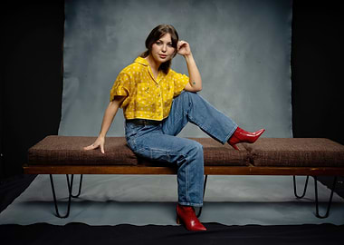 sammi hanratty in yellow shirt and jeans on bench