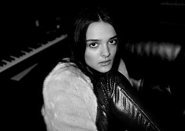 Fashionable charlotte lawrence in a fur coat and shiny pants