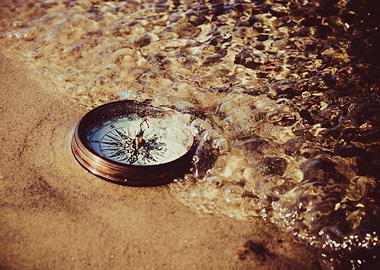Compass on a Sandy Beach Shoreline