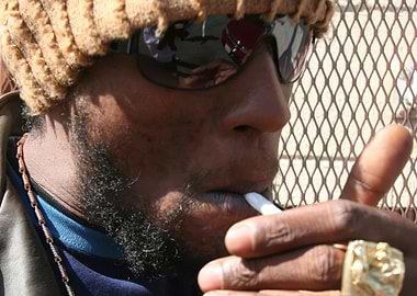 jah mason smoking with sunglasses and beanie