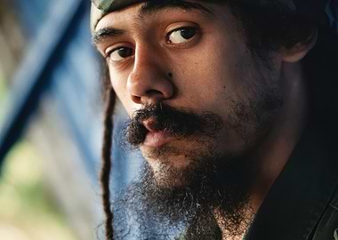 Close-up of a damien marley with dreadlocks