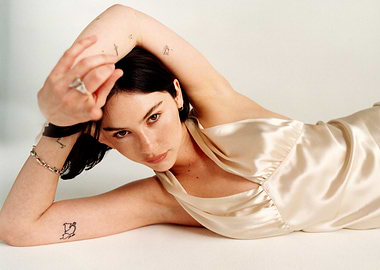 Gracie Abrams in satin dress with tattoos