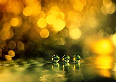 Three marbles on a reflective surface