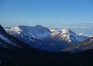 Snow-capped mountains under a clear blue sky at Zugspitze